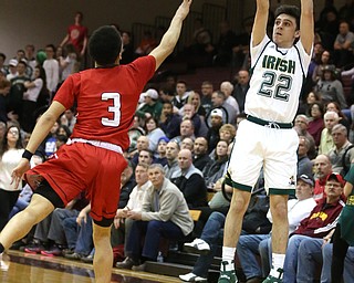Vince Venzio(22) of Ursuline goes up for three as Anthony Backus(3) of Girard tries to block his shot during the 2nd quarter as Girard takes on Ursuline, Thursday, March 9, 2017 at Boardman High School. Ursuline won 62-53...(Nikos Frazier | The Vindicator)..