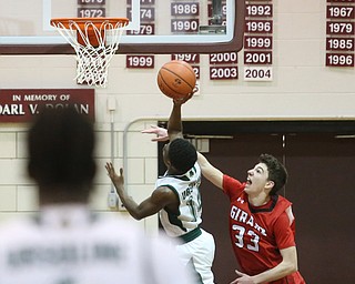 Dakota Hobbs(14) of Ursuline goes up for two as Austin O'Hara(33) of Girard tries to block his shot during the 2nd quarter as Girard takes on Ursuline, Thursday, March 9, 2017 at Boardman High School. Ursuline won 62-53...(Nikos Frazier | The Vindicator)..