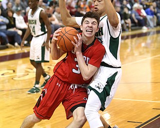 Austin O'Hara(33) of Girard pushes off Devin Keevy(23) of Ursuline during the 2nd quarter as Girard takes on Ursuline, Thursday, March 9, 2017 at Boardman High School. Ursuline won 62-53...(Nikos Frazier | The Vindicator)..