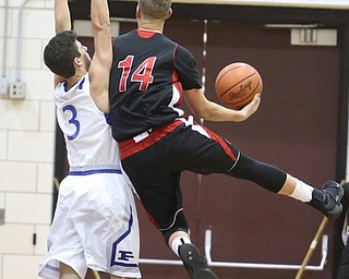 Mitch Davidson(14) of Salem goes up for a layup as he collides with Braeden O'Shaungnessy(3) of Poland during the 2nd half as Salem takes on Poland Seminary, Thursday, March 9, 2017 at Boardman High School. Salem won 70-66...(Nikos Frazier | The Vindicator)..