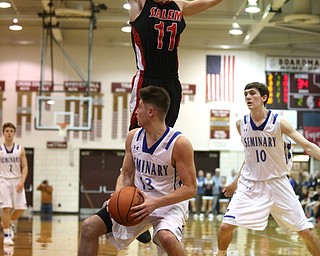 Brandon Barringer(13) of Poland pauses under the net as Turner Johnson(11) of Salem jumps to early to shot his shot during the 2nd half as Salem takes on Poland Seminary, Thursday, March 9, 2017 at Boardman High School. Salem won 70-66...(Nikos Frazier | The Vindicator)..