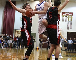 Stephen Bannon(15) of Poland collides with Jon Gerace(5) and Chase Ackerman(24) of Salem while going up for a layup during the 2nd half as Salem takes on Poland Seminary, Thursday, March 9, 2017 at Boardman High School. Salem won 70-66...(Nikos Frazier | The Vindicator)..