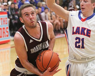 William D Lewis the Vindicator  Boardman'sJohn ryan(1) tries to shoot around Lakes Jeremy Brandy(21.
