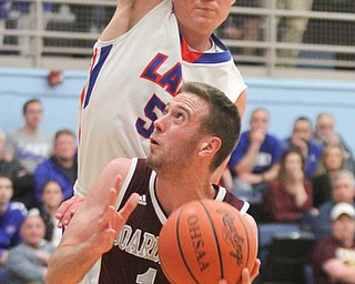 William D Lewis the Vindicator  Boardman'sJohn Ryan(1)) tries toshootaround Lakes Jake Schultz(51).