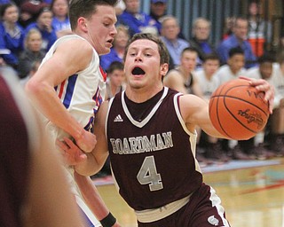 William D Lewis the Vindicator  Boardman'sMike Melewski(4) tries to drivearound Lakes Jake Maranville(25)).