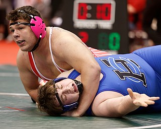 Columbiana's Tim Davin, top, holds Harrison Central's Brenton Stull in a first round 285 match during the Division III Ohio state wrestling tournament at the Ohio State University Thursday, March 9, 2017. (Photo by Paul Vernon)