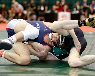 Austintown Fitch's Gus Sutton, left, works against Mason's Colin Schuster in a first round 120 pound  match during the Division I Ohio state wrestling tournament at the Ohio State University Thursday, March 9, 2017. (Photo by Paul Vernon)