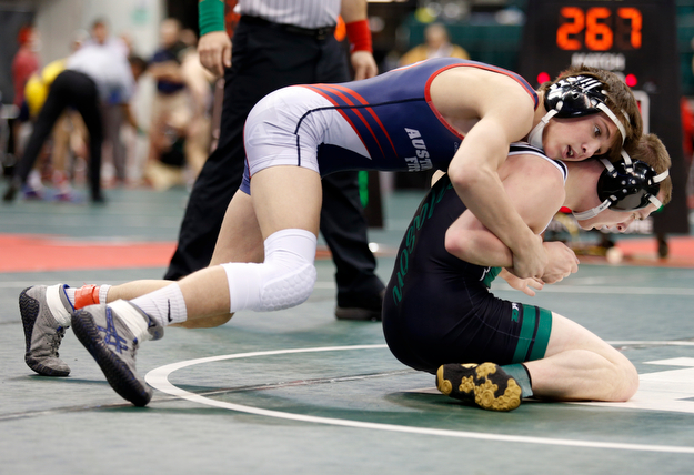 Austintown Fitch's Gus Sutton, left, works against Mason's Colin Schuster in a first round 120 pound  match during the Division I Ohio state wrestling tournament at the Ohio State University Thursday, March 9, 2017. (Photo by Paul Vernon)
