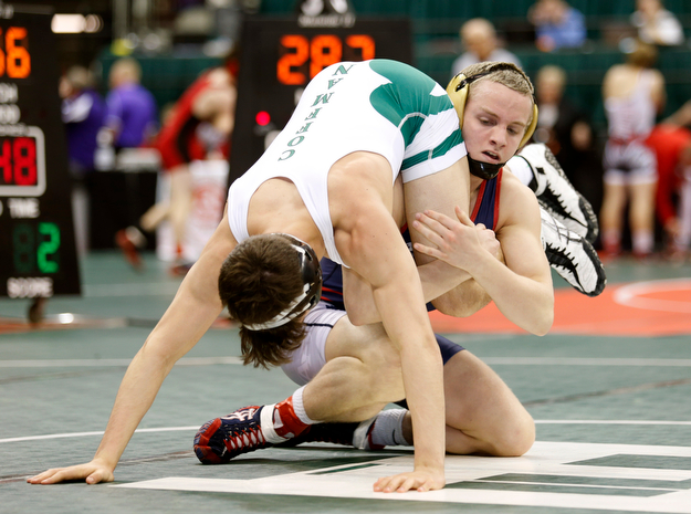 Austintown Fitch's Andrew Fairbanks, right, works against Dublin Coffman's Ben Yost in a first round 138 pound  match during the Division I Ohio state wrestling tournament at the Ohio State University Thursday, March 9, 2017. (Photo by Paul Vernon)