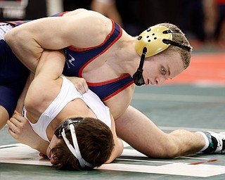 Austintown Fitch's Andrew Fairbanks, top, works against Dublin Coffman's Ben Yost  in a first round 138 pound  match during the Division I Ohio state wrestling tournament at the Ohio State University Thursday, March 9, 2017. (Photo by Paul Vernon)