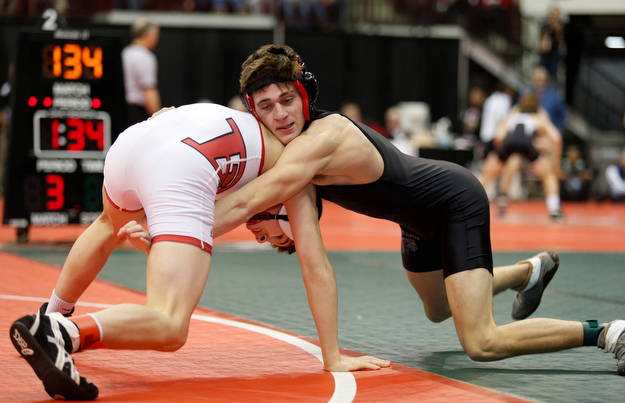 Giard's Dakota McCloskey, right, works against Libson Beaver's Skyler Lasure in a first round 120 pound match during the Division II Ohio state wrestling tournament at the Ohio State University Thursday, March 9, 2017. (Photo by Paul Vernon)