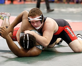 Canfield's Mason Giordano, top, works against Toledo Central Catholic's Craig Demarko in a first round 285 pound  match during the Division II Ohio state wrestling tournament at the Ohio State University Thursday, March 9, 2017. (Photo by Paul Vernon)