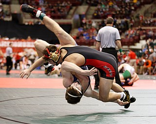 Canfield's Georgio Poullas, top, takes McConnelsville Morgan's Wesley Pauley in to the mat in a first round 160 pound match during the Division II Ohio state wrestling tournament at the Ohio State University Thursday, March 9, 2017. (Photo by Paul Vernon)