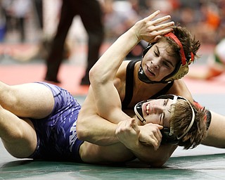 Canfield's Georgio Poullas, top, holds McConnelsville Morgan's Wesley Pauley  in a first round 160 pound match during the Division II Ohio state wrestling tournament at the Ohio State University Thursday, March 9, 2017. (Photo by Paul Vernon)