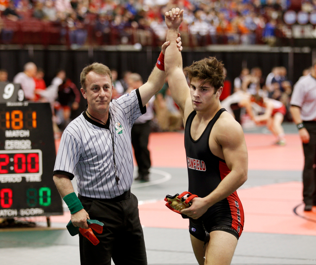 Canfield's Georgio Poullas, right, is declared the winner against  McConnelsville Morgan's Wesley Pauley  in a first round 160 pound match during the Division II Ohio state wrestling tournament at the Ohio State University Thursday, March 9, 2017. (Photo by Paul Vernon)