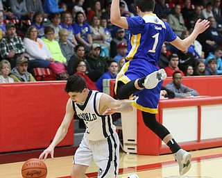 Zach Rasile(1) of McDonald dodges Dominic Pugliano(1) of Southern during the 1st quarter as Southern Local takes on McDonald, Friday, March 10, 2017 at Struthers High School. McDonald won 96-43...(Nikos Frazier | The Vindicator)..