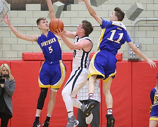 Evan Magill(10) of McDoald goes up for a layup as Max Hart(11) and Jacob Joiner(5) of Southern try to block his shot during the 2nd quarter as Southern Local takes on McDonald, Friday, March 10, 2017 at Struthers High School. McDonald won 96-43...(Nikos Frazier | The Vindicator)..