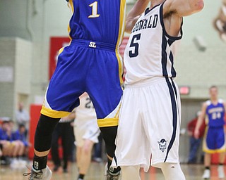 Dominic Pugliano(1) of Southern goes up for a layup as Josh Celli(5) of McDonald follows close by during the 2nd quarter as Southern Local takes on McDonald, Friday, March 10, 2017 at Struthers High School. McDonald won 96-43...(Nikos Frazier | The Vindicator)..