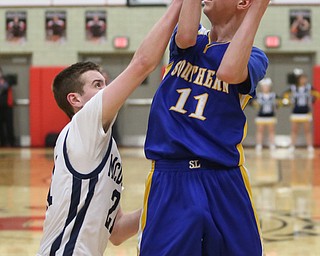 Joe Ragazzine(21) of McDonald reaches for Max Hart(11) of Southern's ball during the 3rd quarter as Southern Local takes on McDonald, Friday, March 10, 2017 at Struthers High School. McDonald won 96-43...(Nikos Frazier | The Vindicator)..