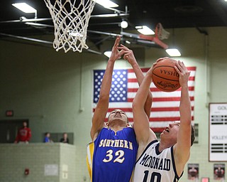 Evan Magill(10) of McDonald and Andre Sloan(32) of Southern reach up for the rebound during the 4th quarter as Southern Local takes on McDonald, Friday, March 10, 2017 at Struthers High School. McDonald won 96-43...(Nikos Frazier | The Vindicator)..