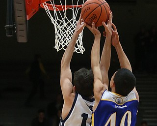 Caleb Emerson(11) of McDonald puts up two as Jayce Sloan(40) of Southern reaches for the ball behind him during the 4th quarter as Southern Local takes on McDonald, Friday, March 10, 2017 at Struthers High School. McDonald won 96-43...(Nikos Frazier | The Vindicator)..