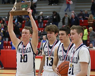Evan Magill(10) of McDonald holds up their first place Division IV trophy after McDonald beat Southern Local, 96-43, Friday, March 10, 2017 at Struthers High School. ..(Nikos Frazier | The Vindicator)..