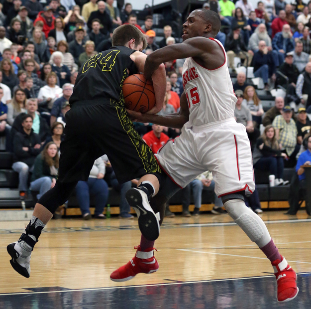 MICHAEL G TAYLOR | THE VINDICATOR- 03-10-17  -Basketball-  2nd qtr., as Labrae's #15 Carlton Brown drives to the hoop, Garfield's #24 Ryan Brown ties him up for a jump ball. Boys high School basketball Garfield G-Men vs Labrae Vikings D3 Distric Finals at Warren G. Harding High School, Warren, OH