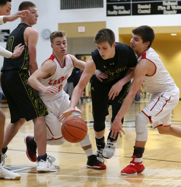 MICHAEL G TAYLOR | THE VINDICATOR- 03-10-17  -Basketball-  2nd qtr., Garfield's #24 Ryan Brown drives between Labrae's #20 Benton Tennant (left) and Labrae's #1 Michael Eakins. Boys high School basketball Garfield G-Men vs Labrae Vikings D3 Distric Finals at Warren G. Harding High School, Warren, OH