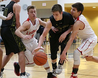 MICHAEL G TAYLOR | THE VINDICATOR- 03-10-17  -Basketball-  2nd qtr., Garfield's #24 Ryan Brown drives between Labrae's #20 Benton Tennant (left) and Labrae's #1 Michael Eakins. Boys high School basketball Garfield G-Men vs Labrae Vikings D3 Distric Finals at Warren G. Harding High School, Warren, OH