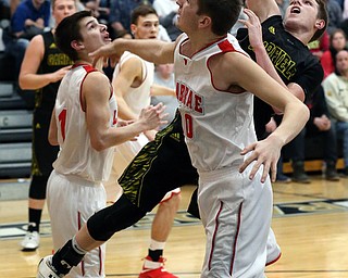 MICHAEL G TAYLOR | THE VINDICATOR- 03-10-17  -Basketball-  4th qtr., Garfield's #24 Ryan Brown drives against Labrae's #10 Logan Kiser. Boys high School basketball Garfield G-Men vs Labrae Vikings D3 Distric Finals at Warren G. Harding High School, Warren, OH