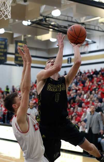 MICHAEL G TAYLOR | THE VINDICATOR- 03-10-17  -Basketball-  4th qtr., Garfield's #0 Zack Smith scores over Labrae's #3 Aaron Iler. Boys high School basketball Garfield G-Men vs Labrae Vikings D3 Distric Finals at Warren G. Harding High School, Warren, OH