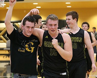 MICHAEL G TAYLOR | THE VINDICATOR- 03-10-17  -Basketball-   After winning the district final, Garfield's #15Dalton Fall (right) and injuried team captain Seth Moragn celebrate. Boys high School basketball Garfield G-Men vs Labrae Vikings D3 Distric Finals at Warren G. Harding High School, Warren, OH