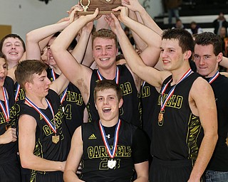 MICHAEL G TAYLOR | THE VINDICATOR- 03-10-17  -Basketball-   After winning the district final, Garfield celebrates with the trophy. Boys high School basketball Garfield G-Men vs Labrae Vikings D3 Distric Finals at Warren G. Harding High School, Warren, OH