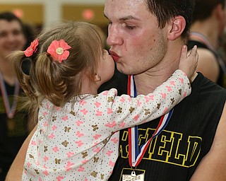 MICHAEL G TAYLOR | THE VINDICATOR- 03-10-17  -Basketball-   After winning the district final, Garfield's #5 Tommy Bissler gets a kiss from his niece Chloe. Boys high School basketball Garfield G-Men vs Labrae Vikings D3 Distric Finals at Warren G. Harding High School, Warren, OH
