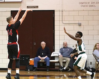 Mitch Davidson(14) of Salem goes up for three as Dakota Hobbs(14) of Ursuline tries to block his shot during the 1st quarter as Salem takes on Ursuline in the Division II District Final, Saturday, March 11, 2017 at Boardman High School. Ursuline won 70-33...(Nikos Frazier | The Vindicator)..