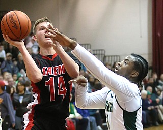 Mitch Davidson(14) of Salem goes up for a layup as Anthony Howell(1) of Ursuline tries to block his shot during the 2nd quarter as Salem takes on Ursuline in the Division II District Final, Saturday, March 11, 2017 at Boardman High School. Ursuline won 70-33...(Nikos Frazier | The Vindicator)..