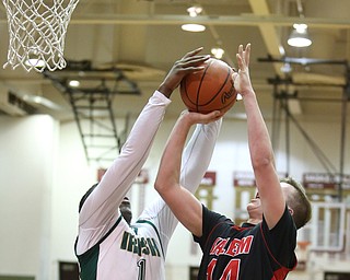 Mitch Davidson(14) of Salem goes up for a layup as Anthony Howell(1) of Ursuline strips him of the ball during the 2nd quarter as Salem takes on Ursuline in the Division II District Final, Saturday, March 11, 2017 at Boardman High School. Ursuline won 70-33...(Nikos Frazier | The Vindicator)..
