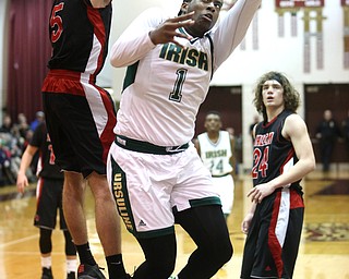 Anthony Howell(1) of Ursuline goes up for a layup as Jon Gerace(5) of Salem tries to block his shot during the 3rd quarter as Salem takes on Ursuline in the Division II District Final, Saturday, March 11, 2017 at Boardman High School. Ursuline won 70-33...(Nikos Frazier | The Vindicator)..