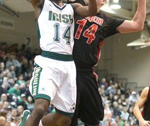 Dakota Hobbs(14) of Ursuline goes up for a layup as Mitch Davidson(14) of Salem tries to block the ball during the 3rd quarter as Salem takes on Ursuline in the Division II District Final, Saturday, March 11, 2017 at Boardman High School. Ursuline won 70-33...(Nikos Frazier | The Vindicator)..