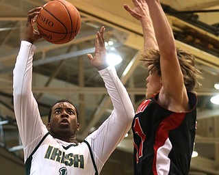 Anthony Howell(1) of Ursuline goes up for a layup as Turner Johnson(11) of Salem tries to block his shot during the 4th quarter as Salem takes on Ursuline in the Division II District Final, Saturday, March 11, 2017 at Boardman High School. Ursuline won 70-33...(Nikos Frazier | The Vindicator)..
