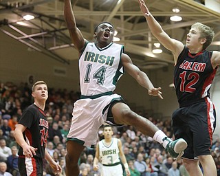 Dakota Hobbs(14) of Ursuline goes up for a layup as Braydon Gibson(12) of Salem tries to block his shot during the 4th quarter as Salem takes on Ursuline in the Division II District Final, Saturday, March 11, 2017 at Boardman High School. Ursuline won 70-33...(Nikos Frazier | The Vindicator)..