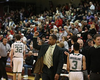 Ursuline Head Coach Keith Gunther celebrates after Ursuline beat Salem, 70-33 in the Division II District Final, Saturday, March 11, 2017 at Boardman High School. ..(Nikos Frazier | The Vindicator)..