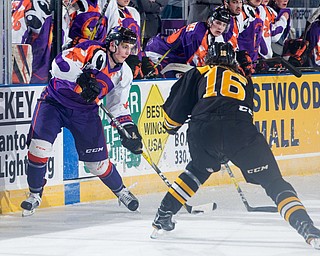 Scott R. Galvin | The Vindicator.Youngstown Phantoms forward Tommy Apap (21) skates the puck around Green Bay Gamblers defenseman Alexis Binner (16) during the second period at the Covelli Centre on March 4, 2017...