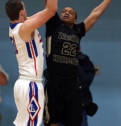 MICHAEL G TAYLOR | THE VINDICATOR- 03-11-17  -Basketball-  2nd qtr, Harding's #22 Lynn Williams defends against Lake's #31 Josh Hutcherson. D1 District Final- Warren G. Harding Raiders vs Uniontown Lake Blue Streaks at Alliance High School in Alliance, OH