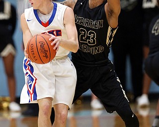 MICHAEL G TAYLOR | THE VINDICATOR- 03-11-17  -Basketball-  2nd qtr, Harding's #23 Chris Hughes defends against Lake's #3 Jim Kirven. D1 District Final- Warren G. Harding Raiders vs Uniontown Lake Blue Streaks at Alliance High School in Alliance, OH