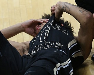 MICHAEL G TAYLOR | THE VINDICATOR- 03-11-17  -Basketball- 3rd qtr., Harding's #0 Tiryn Frank goes down with an injury. D1 District Final- Warren G. Harding Raiders vs Uniontown Lake Blue Streaks at Alliance High School in Alliance, OH