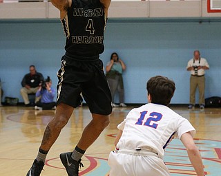 MICHAEL G TAYLOR | THE VINDICATOR- 03-11-17  -Basketball-  1st qtr., Harding's #4 Lynn Bowden shoots over Lake's #12 Niko Perrin. D1 District Final- Warren G. Harding Raiders vs Uniontown Lake Blue Streaks at Alliance High School in Alliance, OH