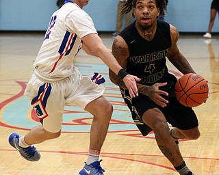 MICHAEL G TAYLOR | THE VINDICATOR- 03-11-17  -Basketball-  1st qtr., Harding's #4 Lynn Bowden drives against Lake's #12 Niko Perrin. D1 District Final- Warren G. Harding Raiders vs Uniontown Lake Blue Streaks at Alliance High School in Alliance, OH