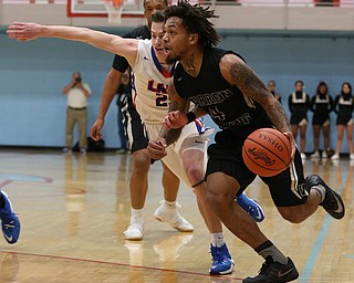 MICHAEL G TAYLOR | THE VINDICATOR- 03-11-17  -Basketball-  1st qtr., Harding's #4 Lynn Bowden drives by Lake's #25 Jake Maranville. D1 District Final- Warren G. Harding Raiders vs Uniontown Lake Blue Streaks at Alliance High School in Alliance, OH