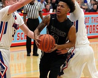MICHAEL G TAYLOR | THE VINDICATOR- 03-11-17  -Basketball-  1st qtr., Harding's #23 Chris Hughes drives through Lake's #3 Jim Kirven and Lake's #45 Matt Spotleson. D1 District Final- Warren G. Harding Raiders vs Uniontown Lake Blue Streaks at Alliance High School in Alliance, OH